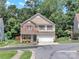 Charming home with a partial brick facade, a covered front porch, and a two-car garage at 15203 Oldcorn Ln, Charlotte, NC 28262