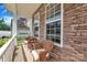 Inviting front porch with stone accents, comfortable seating, and bright natural light at 15203 Oldcorn Ln, Charlotte, NC 28262