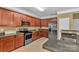 Spacious kitchen features granite countertops, wooden cabinets, and stainless steel appliances at 15203 Oldcorn Ln, Charlotte, NC 28262