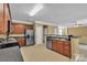 Open kitchen boasts stainless steel appliances, granite countertops, and ceramic tile flooring at 15203 Oldcorn Ln, Charlotte, NC 28262