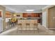 Open kitchen with bar seating, stainless steel appliances, and dark wood cabinets at 15203 Oldcorn Ln, Charlotte, NC 28262