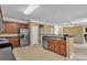 Open kitchen boasts stainless steel appliances, granite countertops, and ceramic tile flooring at 15203 Oldcorn Ln, Charlotte, NC 28262