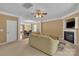 Spacious living room connects to dining area and features a fireplace and neutral decor at 15203 Oldcorn Ln, Charlotte, NC 28262