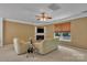 Cozy living room with a fireplace, large window, and comfortable seating at 15203 Oldcorn Ln, Charlotte, NC 28262
