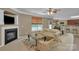 Inviting living room featuring a fireplace, plush sofas, and lots of natural light at 15203 Oldcorn Ln, Charlotte, NC 28262
