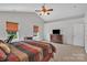 Bright main bedroom features a ceiling fan, carpet flooring, and natural light through the windows at 15203 Oldcorn Ln, Charlotte, NC 28262