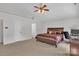 Bright main bedroom features a ceiling fan, carpet flooring, and natural light through the windows at 15203 Oldcorn Ln, Charlotte, NC 28262