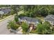 Aerial view of townhomes with manicured lawns, mature trees, and a view of the surrounding neighborhood at 15432 Coventry Court Ln, Charlotte, NC 28277