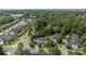 Picturesque aerial view of residential townhomes nestled among mature trees and landscaped yards in a suburban neighborhood at 15432 Coventry Court Ln, Charlotte, NC 28277