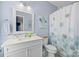 Bathroom with white vanity, framed mirror, and floral shower curtain at 15432 Coventry Court Ln, Charlotte, NC 28277