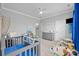 Bedroom with gray walls, white trim, crib, and changing table at 15432 Coventry Court Ln, Charlotte, NC 28277