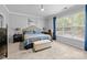 Primary bedroom with large windows and blue bedding at 15432 Coventry Court Ln, Charlotte, NC 28277