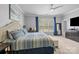 Bright bedroom featuring neutral walls, soft carpet, a ceiling fan, and a large window with natural light at 15432 Coventry Court Ln, Charlotte, NC 28277