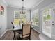 Bright dining room with modern chandelier, large windows, and outside access at 15432 Coventry Court Ln, Charlotte, NC 28277