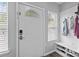 Bright entryway features a coat rack, bench, and laminate flooring at 15432 Coventry Court Ln, Charlotte, NC 28277