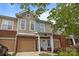 Charming townhome with tan siding, brick accents, and an attached single car garage at 15432 Coventry Court Ln, Charlotte, NC 28277