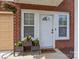 Inviting front entrance features a white door, sidelight windows, and a charming 'Welcome' mat at 15432 Coventry Court Ln, Charlotte, NC 28277