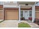 Inviting front entrance features a covered porch with garage and tidy landscaping at 15432 Coventry Court Ln, Charlotte, NC 28277