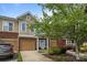Beautiful townhome with brick facade, a well-maintained lawn, and attached garage at 15432 Coventry Court Ln, Charlotte, NC 28277