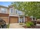 Charming townhome with brick accents, a private garage, and a well-manicured lawn at 15432 Coventry Court Ln, Charlotte, NC 28277