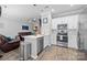 Modern kitchen with stainless steel appliances and white cabinets, open to living area at 15432 Coventry Court Ln, Charlotte, NC 28277
