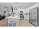 Bright kitchen with stainless steel appliances, white cabinetry and views of the living area at 15432 Coventry Court Ln, Charlotte, NC 28277