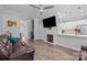 Living room featuring a fireplace, laminate flooring and open access to the kitchen at 15432 Coventry Court Ln, Charlotte, NC 28277