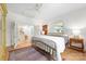 Light-filled bedroom featuring a bed, hardwood floors, and an attached space with a kitchen island at 1801 E 8Th St, Charlotte, NC 28204