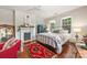 Inviting bedroom featuring a decorative fireplace, windows, and a comfortable bed with patterned quilt at 1801 E 8Th St, Charlotte, NC 28204