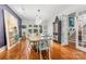 Elegant dining room features hardwood floors, statement art, and view of stairs plus backyard at 1801 E 8Th St, Charlotte, NC 28204