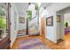 Charming foyer with hardwood floors, stairway, bench seat, and decorative art at 1801 E 8Th St, Charlotte, NC 28204