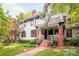Lovely two-story home featuring a cozy porch with wicker chairs and an upper-level balcony, perfect for unwinding at 1801 E 8Th St, Charlotte, NC 28204