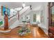 Inviting foyer with hardwood floors, staircase, and decorative table with a circular rug at 1801 E 8Th St, Charlotte, NC 28204