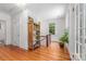 Hallway featuring hardwood floors, natural light, and a decorative shelf with greenery at 1801 E 8Th St, Charlotte, NC 28204