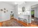 Bright hallway featuring hardwood floors, area rug, white walls, and a glimpse of the bedroom at 1801 E 8Th St, Charlotte, NC 28204