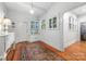 Hallway features hardwood floors, area rug, white walls, built-in cabinets, and natural light at 1801 E 8Th St, Charlotte, NC 28204