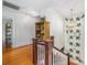 Second story hallway with hardwood floors, an ornate light fixture, and decorative wall art at 1801 E 8Th St, Charlotte, NC 28204