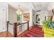 Upstairs hallway boasting a chandelier and beautiful hardwood floors leading to bedrooms and bathrooms at 1801 E 8Th St, Charlotte, NC 28204