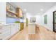 Spacious kitchen with a center island, custom cabinets, vintage yellow appliances, and hardwood floors at 1801 E 8Th St, Charlotte, NC 28204