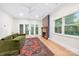 Bright living room featuring a fireplace, plush green couch, and access to the backyard at 1801 E 8Th St, Charlotte, NC 28204