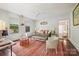 Cozy living room with a comfortable sofa, ceiling fan, and windows at 1801 E 8Th St, Charlotte, NC 28204