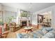 Cozy living room with a fireplace, hardwood floors, and a view into the adjacent dining area at 1801 E 8Th St, Charlotte, NC 28204