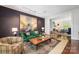 Comfortable living room with dark accent wall, green sofa, and classic decor at 1801 E 8Th St, Charlotte, NC 28204