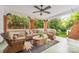 Relaxing outdoor porch with wicker furniture, ceiling fan, and views of lush greenery at 1801 E 8Th St, Charlotte, NC 28204