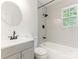 Bathroom with gray shower tiles and gray vanity sink at 1831 Erie St, Charlotte, NC 28216