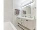 Elegant bathroom featuring double vanity sinks, hexagon pattern tiles, and bright lighting at 1831 Erie St, Charlotte, NC 28216