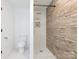 Bathroom with shower, toilet, and earth tone accent tiles at 1831 Erie St, Charlotte, NC 28216