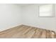 Bedroom featuring hardwood floors and a window at 1831 Erie St, Charlotte, NC 28216