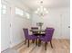 Charming dining area with elegant chandelier and stylish purple upholstered chairs at 1831 Erie St, Charlotte, NC 28216