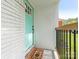 A welcoming turquoise front door with a decorative welcome mat and a sturdy railing at 1831 Erie St, Charlotte, NC 28216